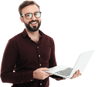 A smiling man holding a laptop